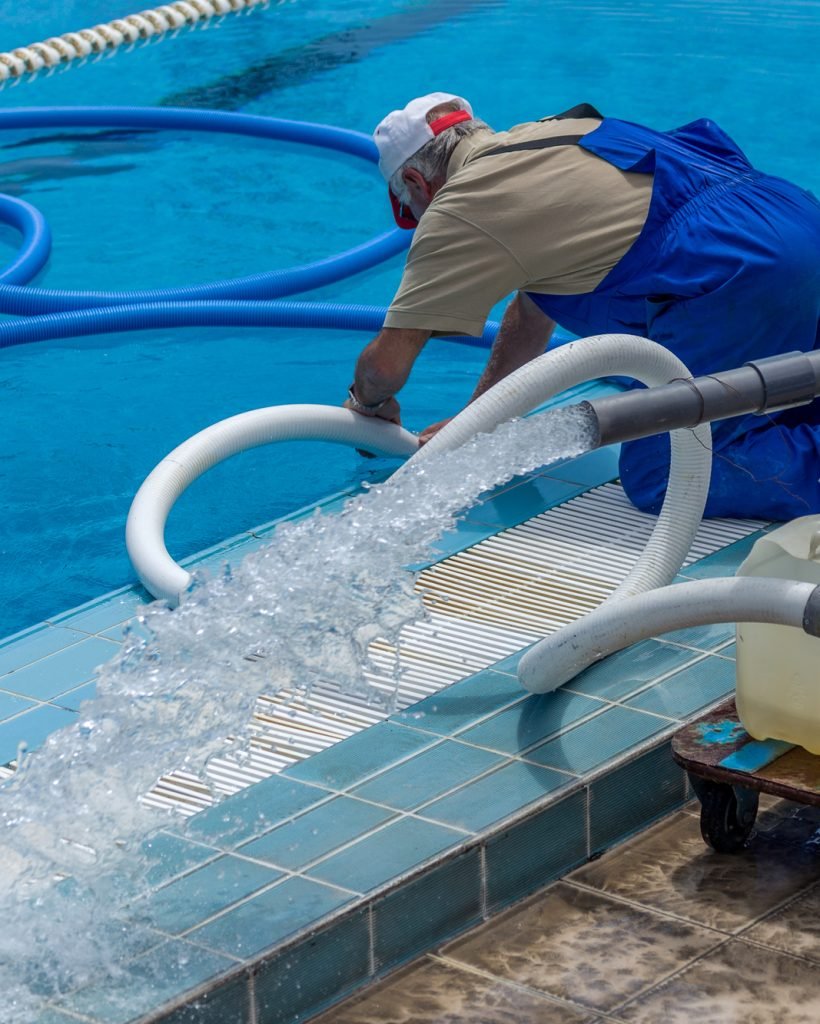 Cleaning the sports pool with a cleaning water pump. The water pump filters the water from the bottom of the pool, cleans from dirt and debris. The cleaning pump works with the pool.